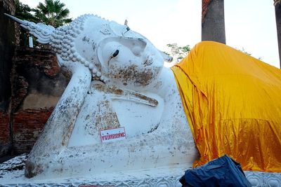 Statue of buddha against building