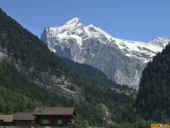 Scenic view of snowcapped mountains against clear sky