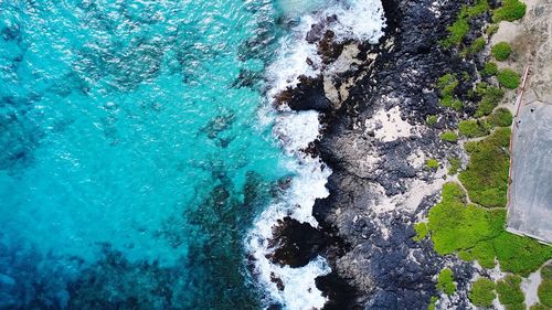 High angle view of rocks in sea