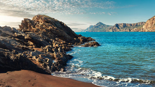 Scenic view of sea against rocky coastline