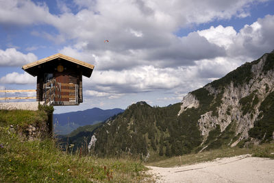 Scenic view of building by mountains against sky