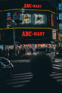 People walking on street in city at night