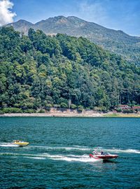 Two speedboats are passing through the sarangan lake magetan indonesia