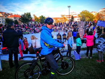 People on bicycles against sky