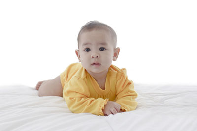 Portrait of cute baby girl in bed