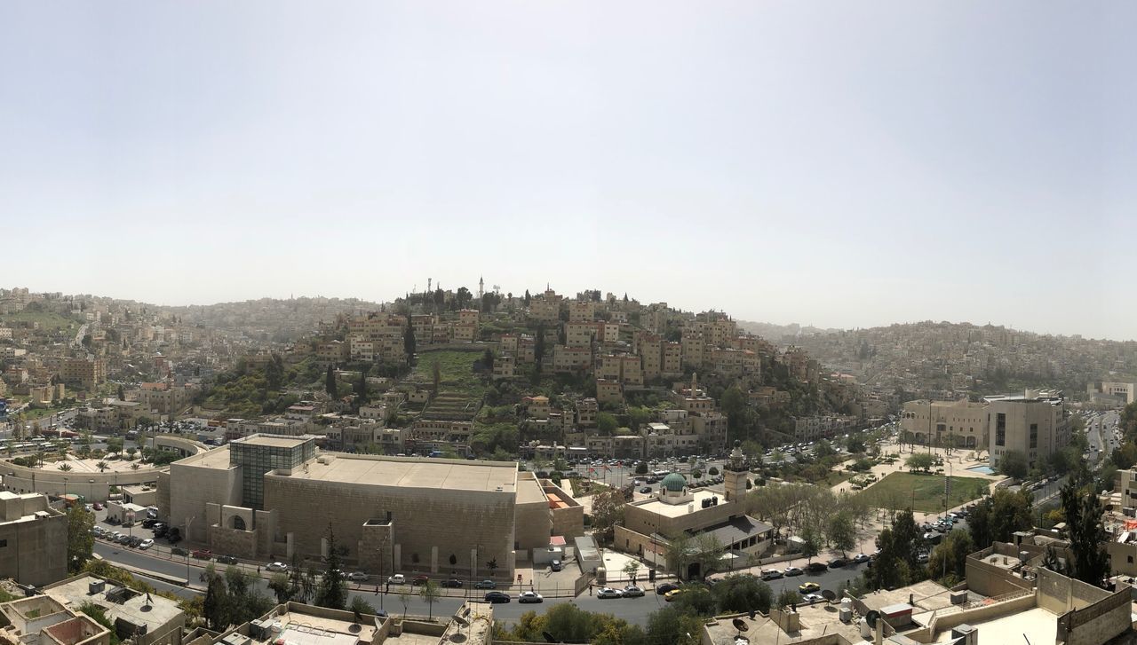 HIGH ANGLE VIEW OF BUILDINGS IN CITY AGAINST CLEAR SKY