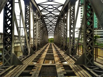 Railroad tracks amidst bridge