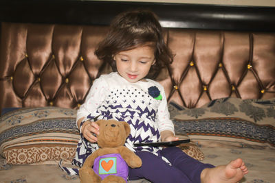 Portrait of smiling girl sitting indoors