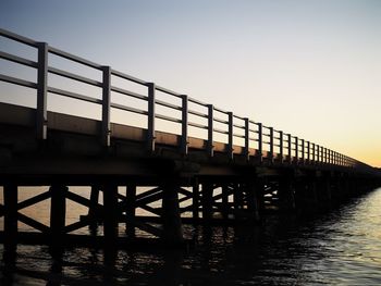 View of bridge over river against clear sky