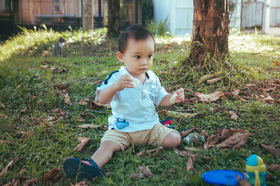 Cute boy playing on field