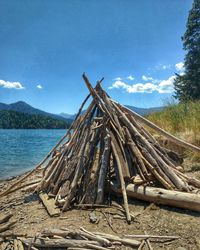 Stack of logs against sky