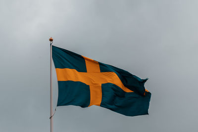 Low angle view of flag against sky