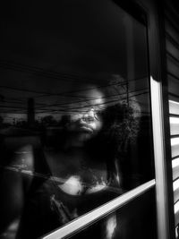 Man seen through window at night