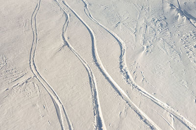 High angle view of tire tracks on land