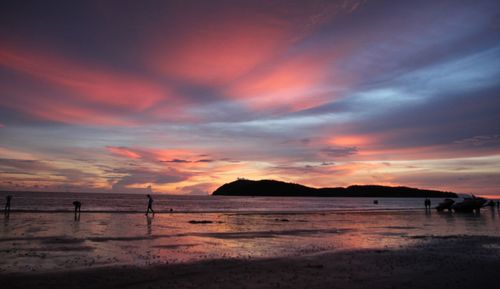 Scenic view of beach against sky during sunset