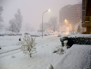 Snow covered street in city during winter