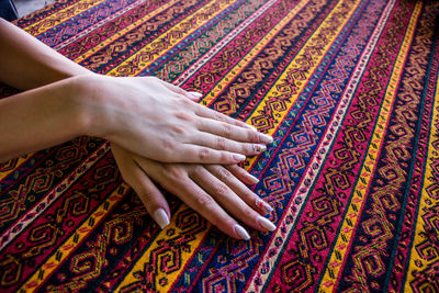 Cropped hands of woman touching patterned fabric