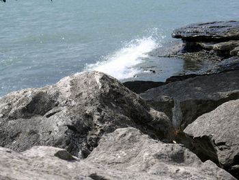 High angle view of rocks at sea shore