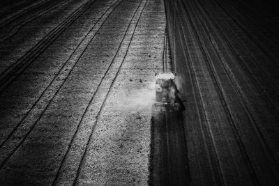 High angle view of people riding bicycle on railroad tracks