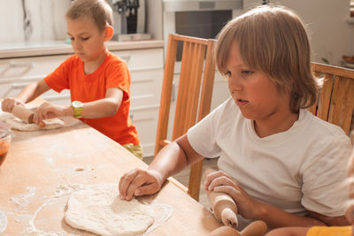 Sibling preparing food at home