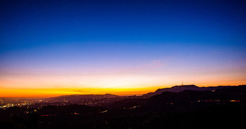 Scenic view of silhouette mountains against sky at sunset