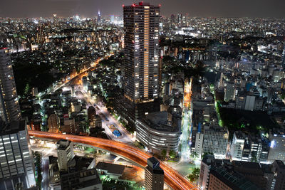 High angle view of illuminated city buildings at night