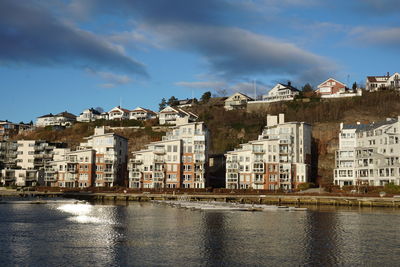 Buildings in city against cloudy sky