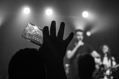 Close-up of hand holding illuminated light bulb at night