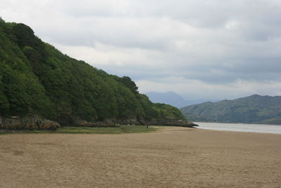 Scenic view of mountains against cloudy sky