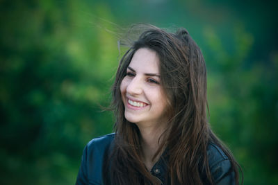 Close-up of happy young woman looking away