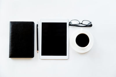 Directly above shot of coffee cup on table against white background