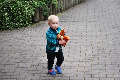 Full length portrait of happy boy eating food