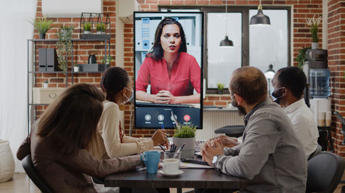 Business colleagues talking on video conference at office