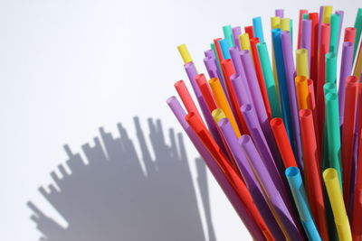 High angle view of colored pencils on white background