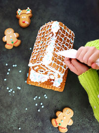 Woman decorating cookie cake with cream