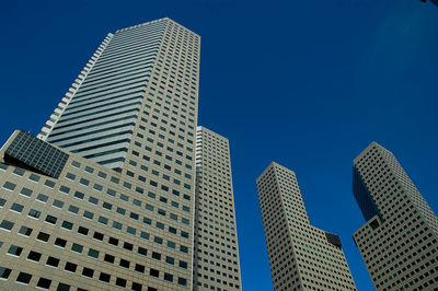 Low angle view of modern building against clear blue sky