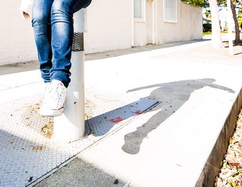 Low section of woman standing on tiled floor