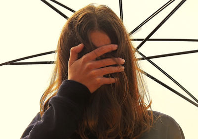 Close-up of woman against umbrella