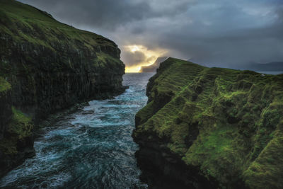 Rock formation amidst sea against sky