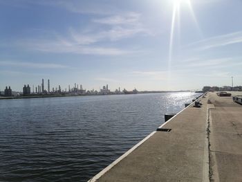 Panoramic view of river and cityscape against sky