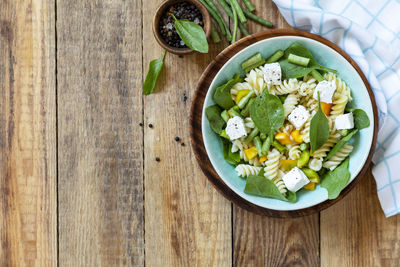 Cold delicious pasta salad, italian cuisine. whole wheat fusilli pasta with feta, green bean. 