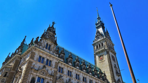 Low angle view of historical building against blue sky