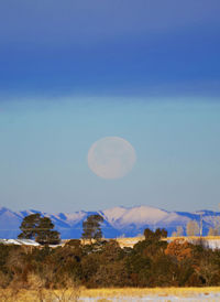 Scenic view of mountains against blue sky