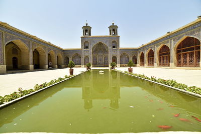 View of pond in front of building