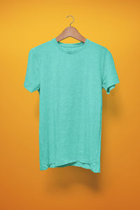 Close-up of blue paint hanging against orange background