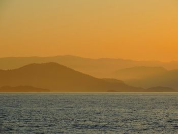 Scenic view of sea against clear sky during sunset