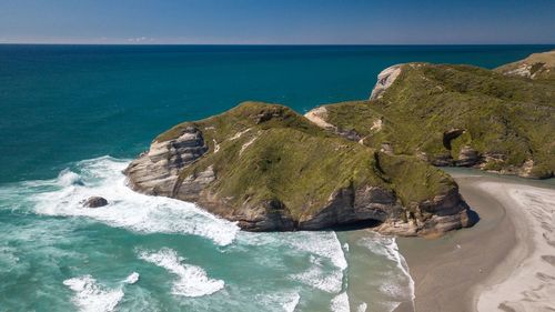 Rocks on sea shore against sky
