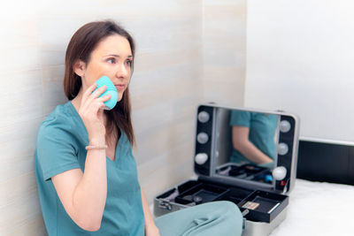 Portrait of woman holding smart phone