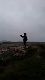 Full length of woman standing on landscape