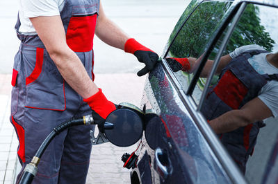 Low section of man cleaning car